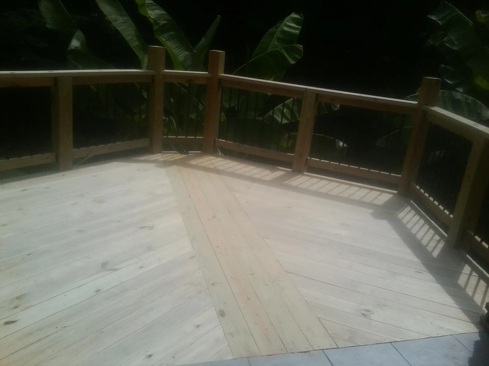 New wood deck and railing built off the back of a home in New Lebanon